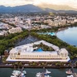 Aerial view of Cairns Esplanade, marina, and city skyline with mountain backdrop