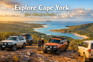 4WD vehicles overlooking Cape York coastline at sunset
